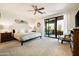 Bright main bedroom with ceiling fan, access to private patio and carpeted floor at 13300 E Via Linda Dr # 1058, Scottsdale, AZ 85259
