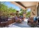 Relaxing covered patio with wicker chairs, desert decor, and views of the landscaped surroundings at 13300 E Via Linda Dr # 1058, Scottsdale, AZ 85259