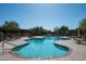 Community pool is surrounded by comfortable lounge chairs and lush landscaping for a relaxing retreat at 13300 E Via Linda Dr # 1058, Scottsdale, AZ 85259