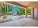 Inviting covered back patio with views of the sparkling pool and well-manicured backyard, perfect for outdoor living at 1470 W Bartlett Way, Chandler, AZ 85248