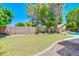 Well-maintained backyard with green lawn, stone landscape and brick perimeter wall at 1470 W Bartlett Way, Chandler, AZ 85248