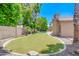 Lush backyard with green lawn, mature trees, and view of the sparkling pool at 1470 W Bartlett Way, Chandler, AZ 85248