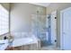 The primary bathroom features a soaking tub with tile surround and a glass enclosed shower at 1470 W Bartlett Way, Chandler, AZ 85248