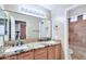 The bathroom features a granite countertop with double sinks and a glass enclosed shower/tub combination at 1470 W Bartlett Way, Chandler, AZ 85248
