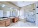 The primary bathroom has double sinks with a granite countertop, walk-in shower and a soaking tub at 1470 W Bartlett Way, Chandler, AZ 85248