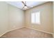 Bedroom featuring neutral walls, carpet flooring, a ceiling fan, and a window with plantation shutters at 1470 W Bartlett Way, Chandler, AZ 85248