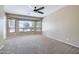 Bright bedroom featuring carpet flooring, a ceiling fan, and large windows that bring in tons of natural light at 1470 W Bartlett Way, Chandler, AZ 85248