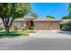 Attractive single-story home with three-car garage, tidy landscaping, and inviting curb appeal at 1470 W Bartlett Way, Chandler, AZ 85248