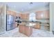 Well-lit kitchen with stainless steel appliances, granite counters, and a convenient center island at 1470 W Bartlett Way, Chandler, AZ 85248
