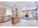 Open-concept kitchen with granite countertops, stainless steel appliances, and travertine floors at 1470 W Bartlett Way, Chandler, AZ 85248