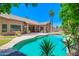 Backyard pool with lush landscaping, palm trees and clear blue sky overhead at 1470 W Bartlett Way, Chandler, AZ 85248