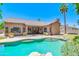 Inviting backyard pool with lush landscaping, rock features, and view of house and patio at 1470 W Bartlett Way, Chandler, AZ 85248