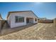 View of the home's backyard, featuring a covered patio and block wall fence, ready for landscaping at 15041 W Gray Fox Trl, Surprise, AZ 85387