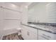 Bathroom features a large vanity, a shower and tub combination and gray-toned wood-look floors at 15041 W Gray Fox Trl, Surprise, AZ 85387