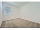 An empty bedroom features carpet, neutral paint and a window at 15041 W Gray Fox Trl, Surprise, AZ 85387