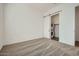Bedroom with a stackable washer and dryer unit visible through an open sliding barn door at 15041 W Gray Fox Trl, Surprise, AZ 85387
