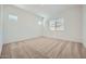 Bright bedroom with neutral carpet, natural light, and ample space at 15041 W Gray Fox Trl, Surprise, AZ 85387
