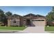 Inviting single-story home with a neutral color palette, stone accents, and a well-manicured lawn at 15041 W Gray Fox Trl, Surprise, AZ 85387