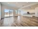 Bright and open living room with wood-look tile flooring and sliding glass doors to the backyard at 15041 W Gray Fox Trl, Surprise, AZ 85387