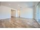 Spacious and bright living area with wood-look tile flooring and large windows at 15041 W Gray Fox Trl, Surprise, AZ 85387