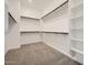 The spacious walk-in closet has built-in shelves and clothing rods at 15041 W Gray Fox Trl, Surprise, AZ 85387