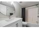 Well-lit bathroom featuring a shower-tub combo and round mirror at 1505 N Center St # 218, Mesa, AZ 85201