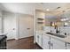 Bright kitchen showcasing stainless steel sink, white cabinetry, and hardwood flooring at 1505 N Center St # 218, Mesa, AZ 85201