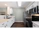 Well-lit kitchen featuring stainless steel appliances, white cabinets, and hardwood floors at 1505 N Center St # 218, Mesa, AZ 85201