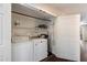 Functional laundry closet featuring washer, dryer, and storage shelves at 1505 N Center St # 218, Mesa, AZ 85201