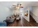 Bright living room features wood floors, a ceiling fan, and an open floor plan to the kitchen at 1505 N Center St # 218, Mesa, AZ 85201