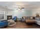Spacious living room boasts wood floors, a ceiling fan, and cozy fireplace at 1505 N Center St # 218, Mesa, AZ 85201
