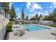 Community pool and hot tub surrounded by lush greenery and clear blue skies at 1505 N Center St # 218, Mesa, AZ 85201