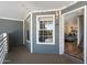 Exterior porch view leading into the living room with updated flooring and fresh paint at 1505 N Center St # 218, Mesa, AZ 85201