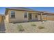 Exterior view of the home's backyard with low-maintenance landscaping, covered patio, and privacy fence at 16762 W Alameda Rd, Surprise, AZ 85387