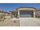 Charming single-story home featuring a stone-accented facade, two-car garage and low maintenance landscaping at 16762 W Alameda Rd, Surprise, AZ 85387