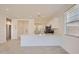 Bright kitchen boasts white cabinets, quartz counters, and modern appliances, perfect for culinary enthusiasts at 16762 W Alameda Rd, Surprise, AZ 85387