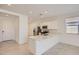 Bright and airy kitchen featuring stainless steel appliances, a large island, and views of the open-concept living area at 16762 W Alameda Rd, Surprise, AZ 85387