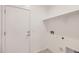 A dedicated laundry area featuring clean, neutral tones, shelving, and ready-to-use connections for appliances at 16762 W Alameda Rd, Surprise, AZ 85387