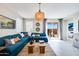 Comfortable living room featuring a large sectional sofa, stylish lighting, and access to the patio at 16762 W Alameda Rd, Surprise, AZ 85387