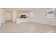 Open-concept living space with a view of the kitchen, featuring tile flooring and lots of natural light at 16762 W Alameda Rd, Surprise, AZ 85387