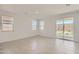Bright living room with tile floors, large sliding glass door, and multiple windows offering ample natural light at 16762 W Alameda Rd, Surprise, AZ 85387