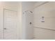Modern white tiled shower with new fixtures and shower rod at 16762 W Alameda Rd, Surprise, AZ 85387