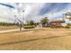 Community baseball field with well-maintained grounds and a covered seating area on a sunny day at 16785 W Montana De Oro Dr, Surprise, AZ 85387