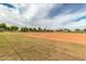 Exterior shot of a well-manicured baseball field on a sunny day with lush green grass at 16785 W Montana De Oro Dr, Surprise, AZ 85387