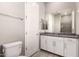Clean, modern bathroom with gray tiling, a vanity with white cabinets, and a view of the walk-in shower at 16785 W Montana De Oro Dr, Surprise, AZ 85387