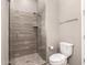 Contemporary bathroom featuring tiled walk-in shower with glass enclosure, a toilet, and modern fixtures at 16785 W Montana De Oro Dr, Surprise, AZ 85387