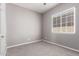 A simple carpeted bedroom with neutral walls and a bright window at 16785 W Montana De Oro Dr, Surprise, AZ 85387