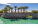 Elegant community entrance featuring lush landscaping, a water feature, and palm trees at 16785 W Montana De Oro Dr, Surprise, AZ 85387