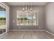 Bright dining room with pendant lighting and a view of the landscaped backyard at 16785 W Montana De Oro Dr, Surprise, AZ 85387