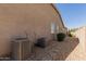Exterior view showing two air conditioning units next to gravel and a stepping stone walkway at 16785 W Montana De Oro Dr, Surprise, AZ 85387